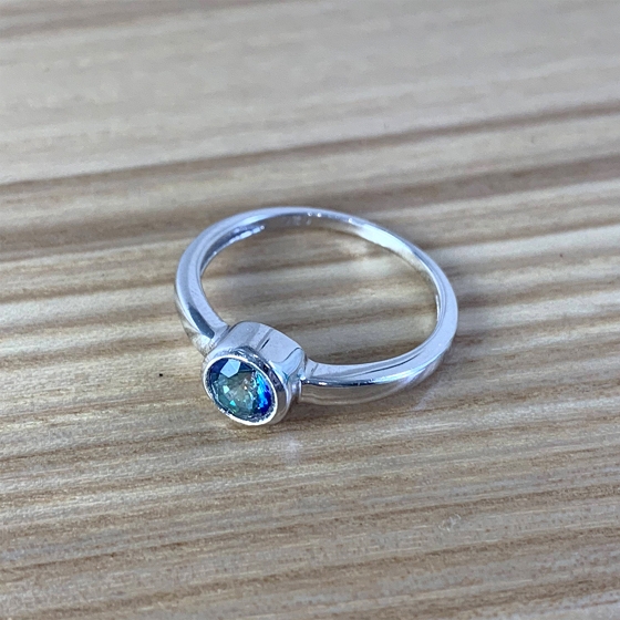 Silver ring with a mystic topaz