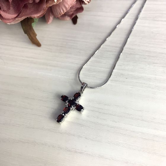 Silver cross with a garnet