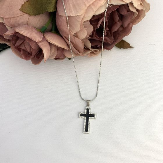 A silver cross with a jewel
