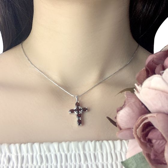 Silver cross with a garnet