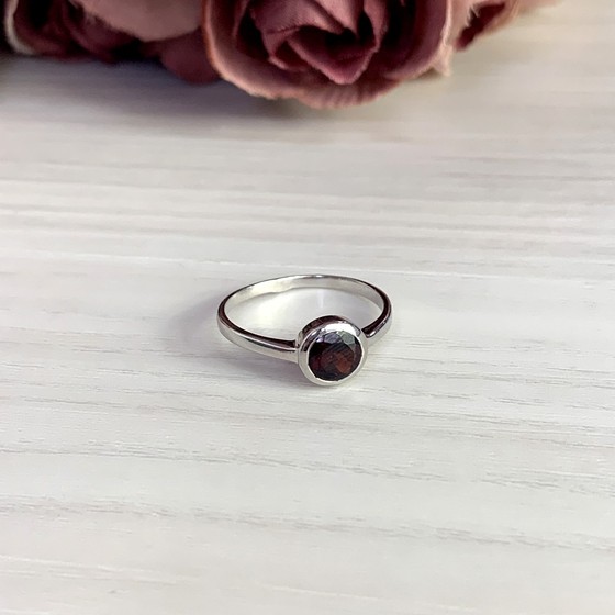 Silver ring with a garnet