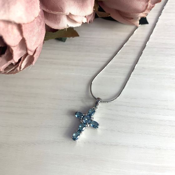 Silver cross with a London Blue topaz