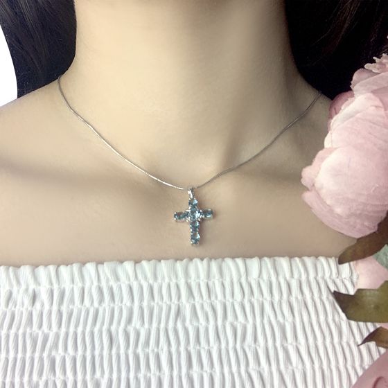 Silver cross with a London Blue topaz