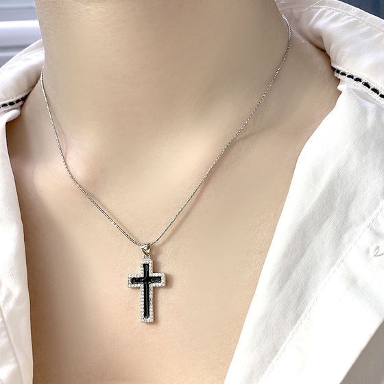 A silver cross with a jewel
