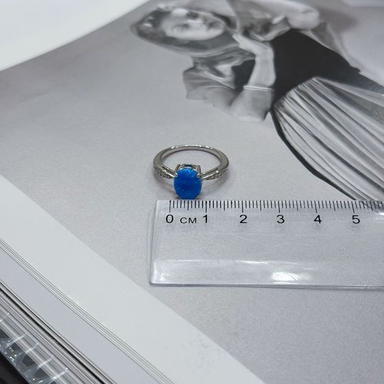 Silver ring with a 0.975-carat opal and cubic zirconia