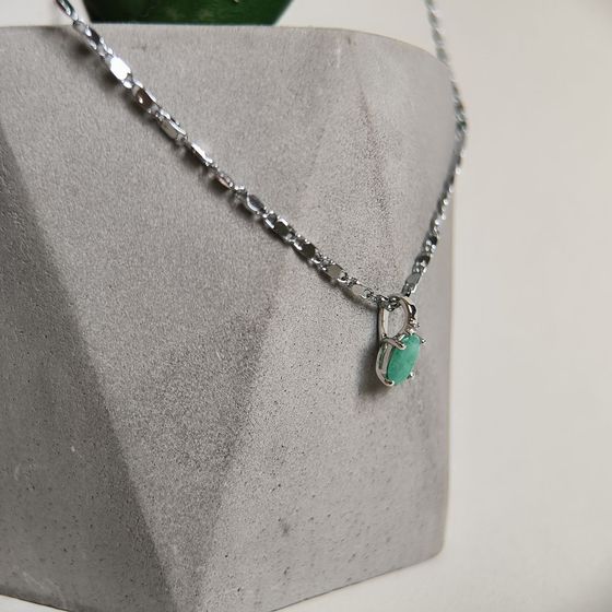 Silver pendant with emerald, fianites