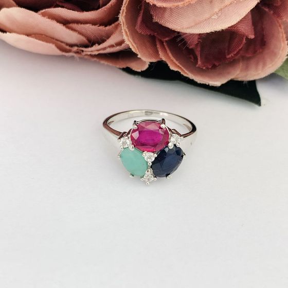 Silver ring with a sapphire, an emerald, and a ruby